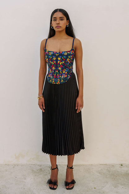 The Zinnia Top is a corset style with embroidered, multicolored flowers and adjustable straps. 