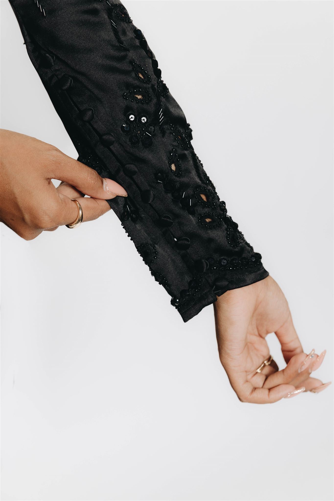 The Rani top is a long sleeve blouse with embellishment and cut work on the sleeves. Dress it up and down, this blouse is the perfect complement to a night out to your next reception. 